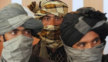 Former Taliban fighters look on during a ceremony after joining Afghan government forces in Herat on August 7, 2013. About 100,000 foreign combat troops, 68,000 of them from the US, are due to exit by the end of 2014, and NATO formally transferred responsibility for nationwide security to Afghan forces a week ago. AFP PHOTO/ Aref Karimi